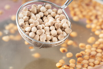 Cooking, boiling brown sugar flavor tapioca pearl balls, ingredient of bubble tea, preparing food and drink, close up, recipe cookbook steps design concept.