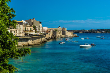 A view across the bay towards Castello Maniace on Ortygia island in Syracuse, Sicily in summer