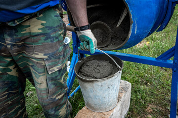A worker brings cement mortar for screed.
