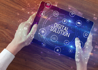 Close-up of a tablet with DIGITAL SOLUTION inscription, innovative technology concept
