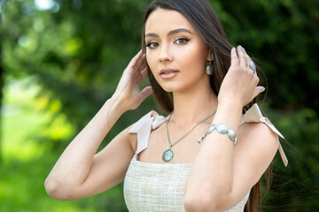 Beautiful girl with set jewelry Woman in a necklace with a ring, earrings and a bracelet. Beauty and accessories