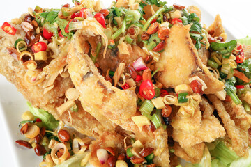 Deep fried freshwater red whole tilapia fish sliced fillet with Thai style lemongrass coriander shallot sauce