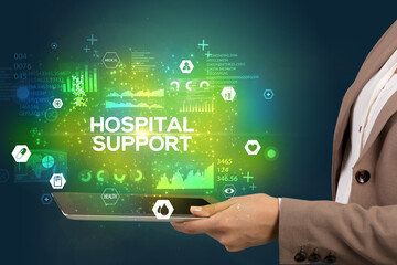 Close-up of a touchscreen with HOSPITAL SUPPORT inscription, medical concept