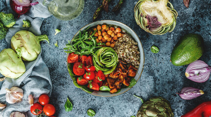 Buddha bowl salad with baked sweet potatoes, chickpeas, quinoa, tomatoes, arugula, avocado, sprouts on light blue background with napkin. Healthy vegan food, clean eating, dieting, top view