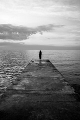 silhouette of a woman on a pier