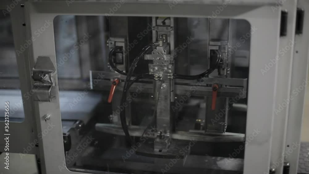 Aufkleber close shot of a printing machine functioning on a factory.