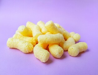Yellow corn sticks on a purple background.