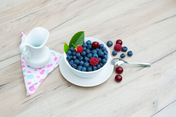blueberries and raspberries for vegans and vegetarians on the wooden table.