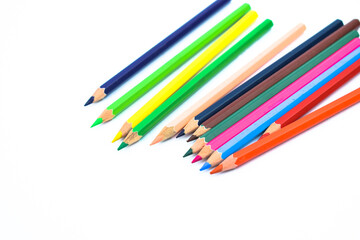 Lot of different colored wood pencil crayon placed in a white background