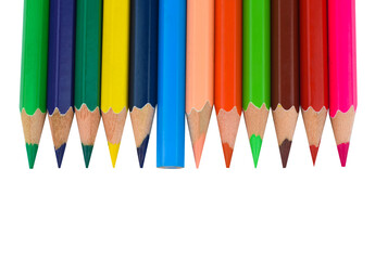 Many different colored wood pencil crayons placed in a line on a paper