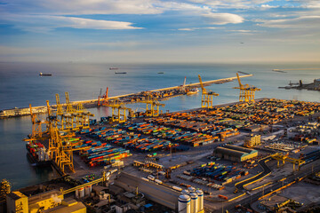 Seaport infrastructure. International port on the sea coast. Harbor cranes industrial equipment and sea containers at the port. Sea port panoramic view. International transportation.