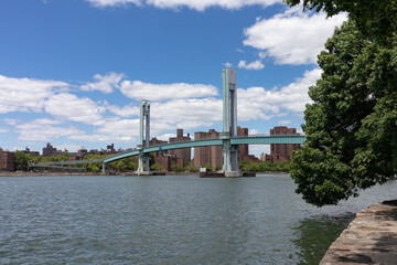 Fototapeta na wymiar Randalls and Wards Islands Riverfront with the Ward's Island Bridge over the East River in New York City