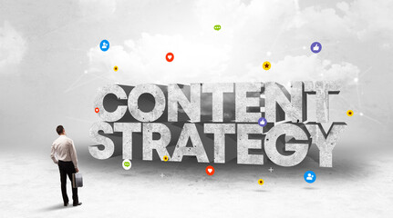 Young businessman standing in front of CONTENT STRATEGY inscription, social media concept