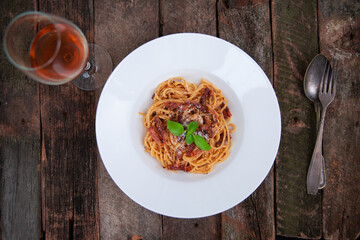 Pasta Carbonara. Spaghetti with bacon, parmesan cheese, and basil leaf.