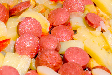 Fried potatoes and sausages with onion for breakfast