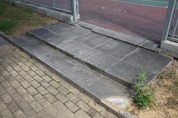 The concrete steps beside the tennis court