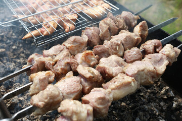 Cooking juicy pork neck on skewers