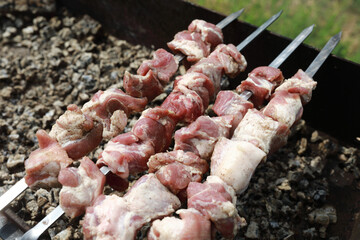 Cooking pork neck on skewers