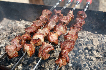 Roasting pork neck on skewers