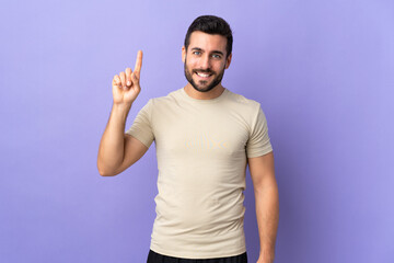 Fototapeta premium Young handsome man with beard over isolated background pointing up a great idea