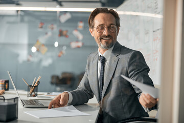 Successful businessman is wearing suit at work