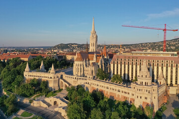 Fototapeta na wymiar The Church of the Assumption in Buda, also known as the Matthias Church, is located in the Fisherman's Bastion, in the Holy Trinity Square. Monument building. aerial view with drone. 