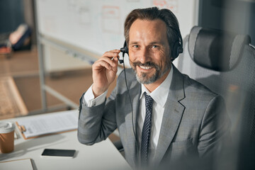 Adult smiling businessman working at the office