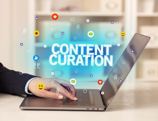 Freelance woman using laptop with CONTENT CURATION inscription, Social media concept