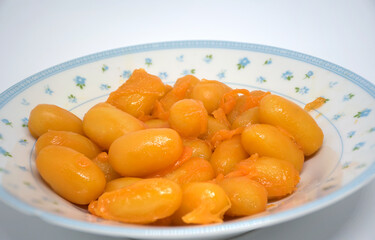 Thai desserts are called Med Kanoon. There is a full yellow color on the plate.