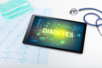 Tablet pc and medical stuff with DIABETES inscription, prevention concept