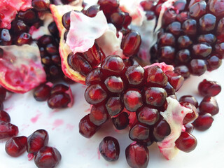 A broken red pomegranate. Macro of pomegranate seeds.