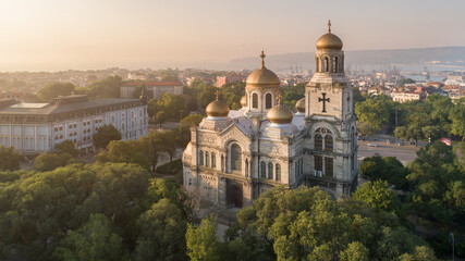 Fototapeta na wymiar Aerial view of the Cathedral of the Assumption on sunrise, Varna Bulgaria. Byzantine style church with golden domes. Varna is the sea capital of Bulgaria.