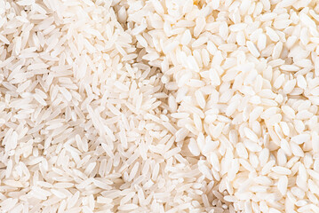 Two types of rice grains seen from above .Arboreo rice, basmati rice. (Top view)