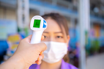 Operator Check Fever by Digital Thermometer Visitor at Information Counter for Scan and Protect...