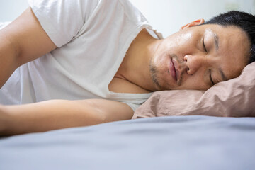 Obraz na płótnie Canvas Peacefulness concept. Handsome man sleeping in bed