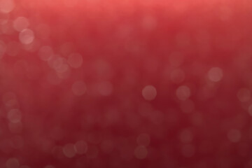 Red glitter vintage lights background. White bokeh on red background.