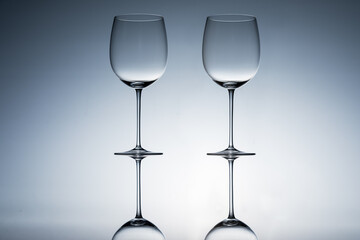 Empty wine glasses on a clean gradient background