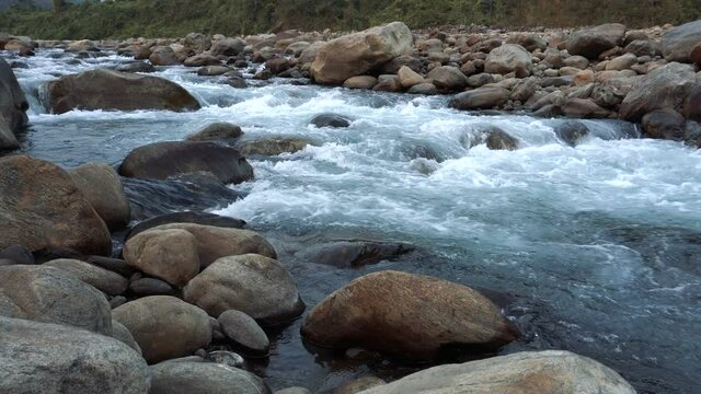 Water flowing on river bed of Joldhaka river, river stcok footage shot at Jhalong, a place of Dooars , north of West Bengal, India.