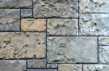 Gothic background with brick wall of stones. Cracks and scratches