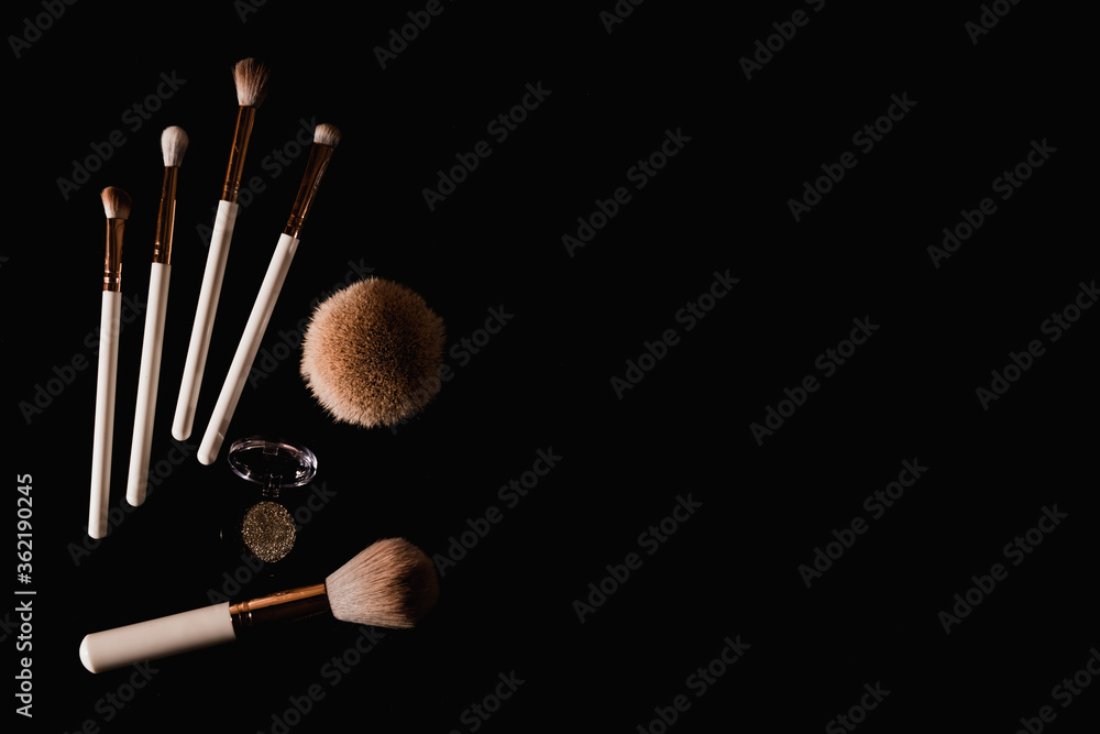 Canvas Prints elegantly lit make-up brushes on a black background