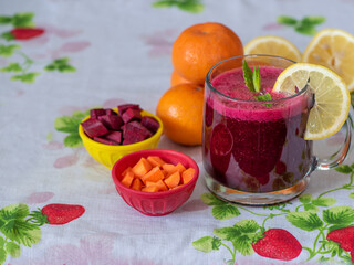 Colorful vegetarian power vitamin juice on colorful table cloth viewed from an angle- health food concept