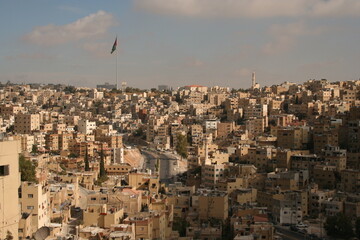 Fototapeta na wymiar Amman Jordan - October 17 2011: City view in the capital of Jordan (Amman) - lots of houses in monochrome sand-color
