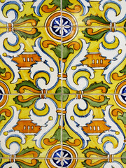 Old mosaic background with decorative details of different colors and shapes. Detail of the old enameled tiles. Old ceramic tiles patterns handicraft.