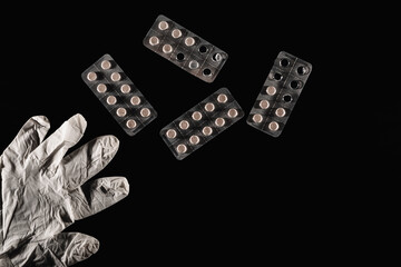 Pills in aluminium packaging isolated on a black background 