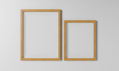 Blank posters in wooden frames on a wall