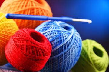 Assortment of different colored yarns and hook for crocheting