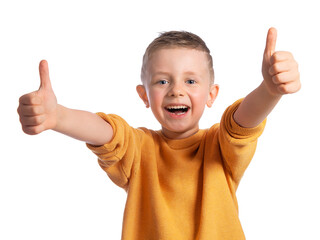 Portrait of a beautiful European boy 6 years old on a white background. The child spreads his hands to the sides and shows the class. Children's emotions.