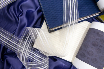 blue fabric catalog with white ribbon