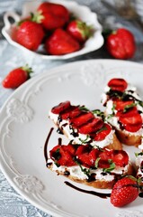 Sandwich with strawberries. With soft cheese and balsamic vinegar. Soft focus.