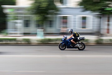 Obraz na płótnie Canvas motorbiker on the city street in motion blur